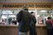 PFD Technician Shilo Franklin, left, helps people process their Permanent Fund Dividend applications at the downtown Anchorage PFD office on Thursday, Mar. 31, 2016. Today is the last day to file for a 2016 PFD. (LOREN HOLMES / Alaska Dispatch News)